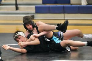Thunder Mountain Middle School wrestler Matvii Kozodoi works a move against schoolmate Caleb Demmert during the inaugural Thunder Mountain Mayhem Team Duels Wrestling Tournament Feb. 1. (Klas Stolpe / Juneau Empire)