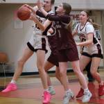 Juneau-Douglas High School: Yadaa.at Kalé senior Kerra Baxter battles for a rebound with Ketchikan junior Lauren Tucker (11) during the Crimson Bears 52-23 win over the Lady Kings on Thursday in Juneau. (Klas Stolpe / Juneau Empire)