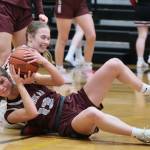 Ketchikan senior Aspen Bauer (13) battles for a loose ball with Juneau-Douglas High School: Yadaa.at Kalé sophomore Bergen Erickson during the Lady Kings 52-23 loss to the Crimson Bears on Thursday in Juneau. (Klas Stolpe / Juneau Empire)