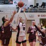 Juneau-Douglas High School: Yadaa.at Kalé senior Addison Wilson (10) shoots under pressure from Ketchikan junior Kylie Brendible (32) and freshman Peyton Nickich (2) during the Crimson Bears 52-23 win over the Lady Kings on Thursday in Juneau. (Klas Stolpe / Juneau Empire)