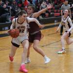 Juneau-Douglas High School: Yadaa.at Kalé senior Kerra Baxter (22) dribbles around Ketchikan junior Kylie Brendible (32) during the Crimson Bears 51-23 win over the Lady Kings on Friday in Juneau. (Klas Stolpe / Juneau Empire)