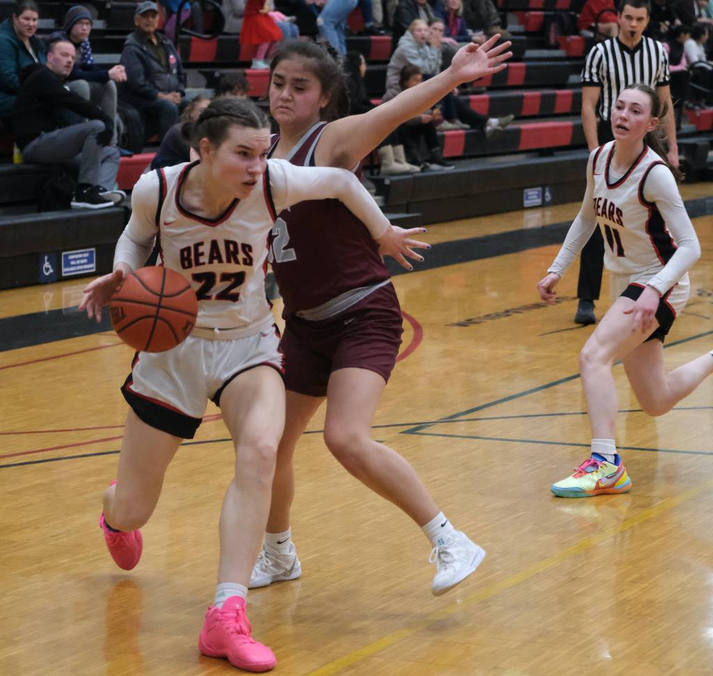 Juneau-Douglas High School: Yadaa.at Kalé senior Kerra Baxter (22) dribbles around Ketchikan junior Kylie Brendible (32) during the Crimson Bears 51-23 win over the Lady Kings on Friday in Juneau. (Klas Stolpe / Juneau Empire)