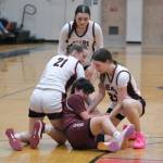Juneau-Douglas High School: Yadaa.at Kalé freshman Athena Warr (21), sophomore Layla Tokuoka (14) and senior Cailynn Baxter (3) battle for a ball with Ketchikan senior Lilli Goodwin during the Crimson Bears 51-23 win over the Lady Kings on Friday in Juneau. (Klas Stolpe / Juneau Empire)