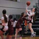 Juneau-Douglas High School: Yadaa.at Kalé sophomore Layla Tokuoka (14) is fouled on a shot by Ketchikan senior Shyla Abajian during the Crimson Bears 51-23 win over the Lady Kings on Friday in Juneau. (Klas Stolpe / Juneau Empire)