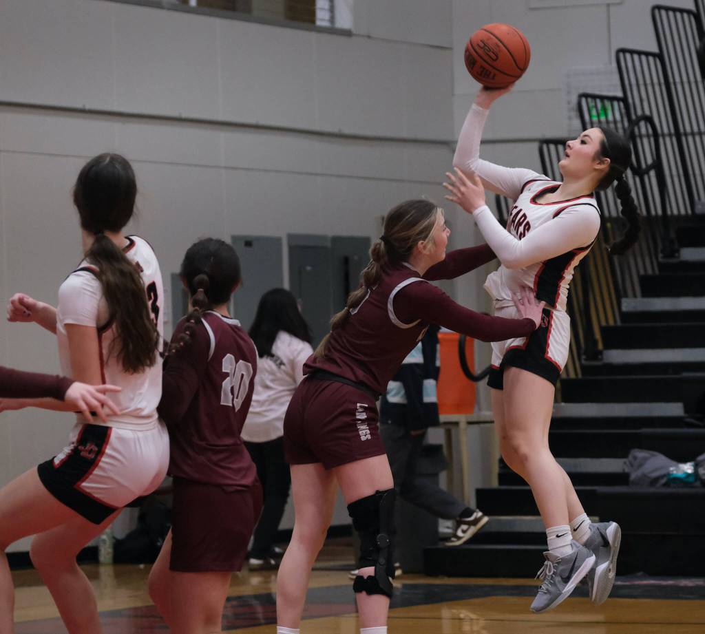 Juneau-Douglas High School: Yadaa.at Kalé sophomore Layla Tokuoka (14) is fouled on a shot by Ketchikan senior Shyla Abajian during the Crimson Bears 51-23 win over the Lady Kings on Friday in Juneau. (Klas Stolpe / Juneau Empire)