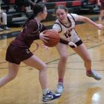 Juneau-Douglas High School: Yadaa.at Kalé sophomore Bergen Erickson (12) attempts to steal a dribble from Ketchikan freshman Peyton Nickich during the Crimson Bears 51-23 win over the Lady Kings on Friday in Juneau. (Klas Stolpe / Juneau Empire)