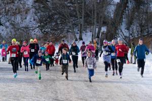 Runners start the Sweetheart Relay on Saturday at Sandy Beach. (Klas Stolpe / Juneau Empire)