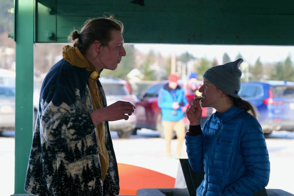 Tim Mikulski and Therese Pokorney enjoy waffles at the Sweetheart Relay on Saturday at Sandy Beach. (Klas Stolpe / Juneau Empire)
