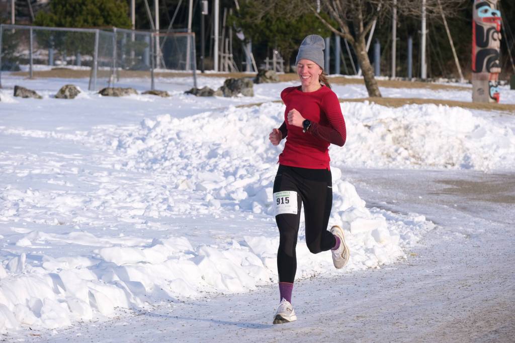 Therese Pokorney (915) finishes the Sweetheart Relay on Saturday at Sandy Beach. (Klas Stolpe / Juneau Empire)