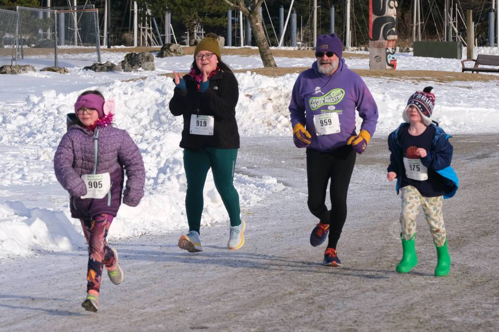 Isabelle Sullivan (905), Jessica Sullivan (919), Guy Crockroft (959) and Dominic Davis (975) run in the Sweetheart Relay on Saturday at Sandy Beach. (Klas Stolpe / Juneau Empire)