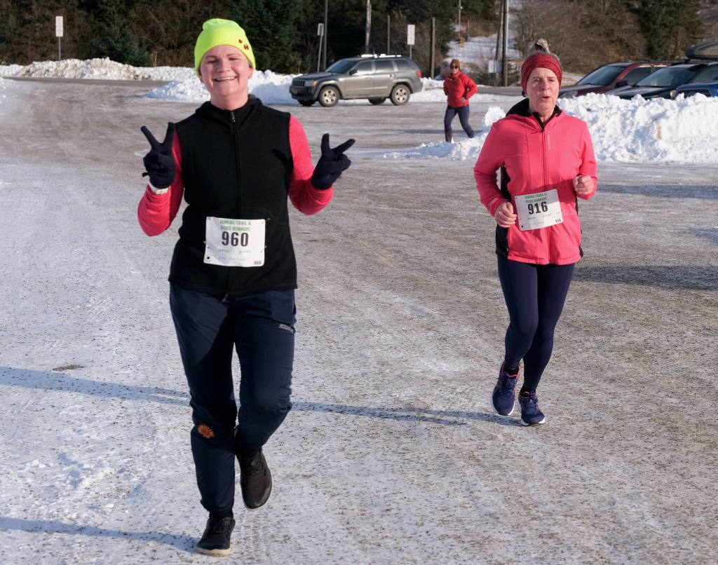 Christina Schulte-Pereyra (960) and Karinne Wiebold (916) finish the Sweetheart Relay on Saturday at Sandy Beach. (Klas Stolpe / Juneau Empire)