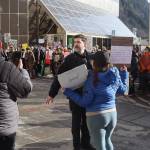 Jeremy Weske, administrative commander of the Juneau Police Department, talks with protesters blocking the street in front of the Alaska State Capitol on Monday. JPD officers ultimately allowed the people to remain on the street during the hour-long event despite the lack of a permit from organizers. (Mark Sabbatini / Juneau Empire)