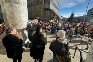 Local organizers and speakers at a No Kings on Presidents Day protest lead a drum chant and dance Monday in front of the Alaska State Capitol. (Mark Sabbatini / Juneau Empire)