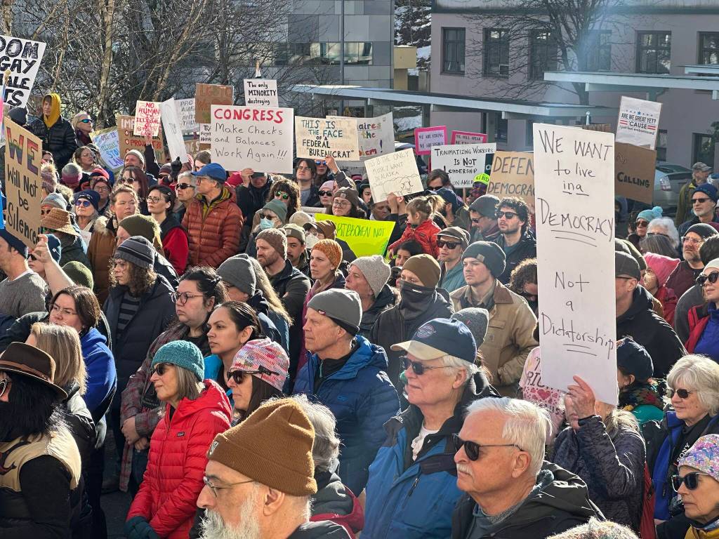 People wave signs expressing concerns about a wide range of issues during a No Kings on Presidents Day protest Monday at the Alaska State Capitol. (Mark Sabbatini / Juneau Empire)