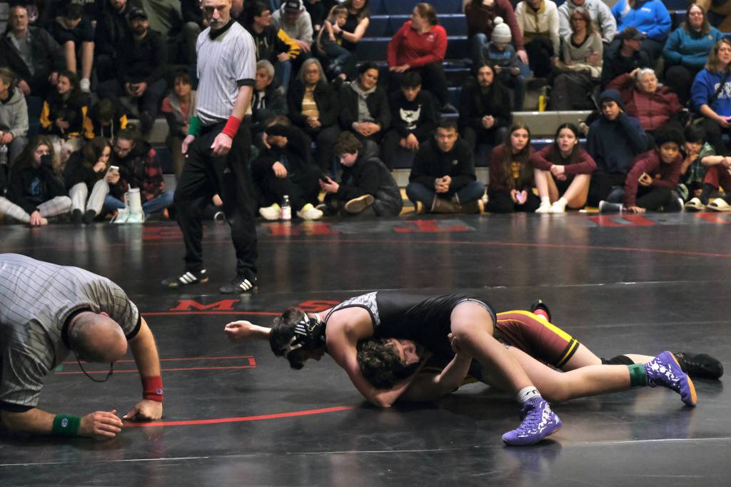 Thunder Mountain Middle School eighth grader Carter Day racks up riding points against Hoonah Braves Tank Tyler in their 141-pound championship during the Southeast Middle School Regional Wrestling Tournament on Saturday at TMMS. (Klas Stolpe / Juneau Empire)