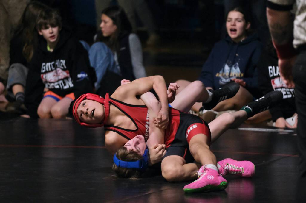Klawocks Charlie Roberts attempts to pin Blatchleys Jene Keith during their 99-pound championship match in the Southeast Middle School Regional Wrestling Tournament on Saturday at Thunder Mountain Middle School. (Klas Stolpe / Juneau Empire)