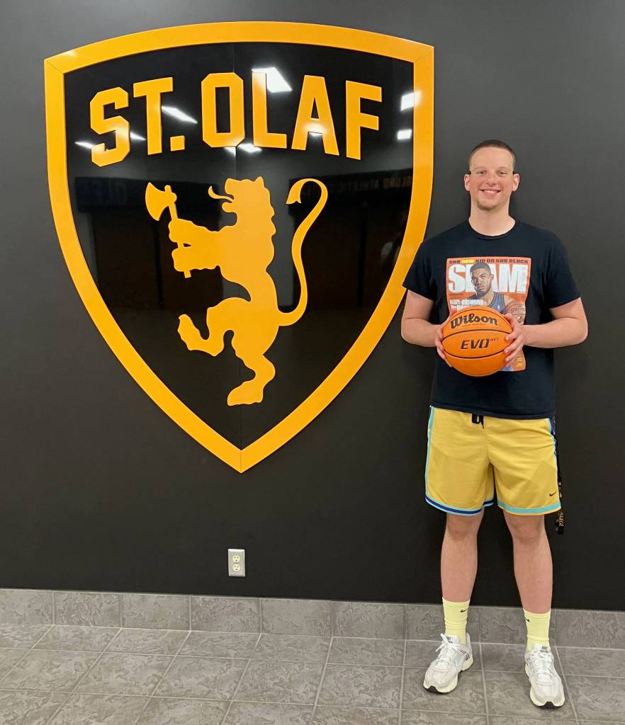 St. Olaf College freshman James Polasky poses next to his colleges logo. (Photo courtesy Kelley Polasky)
