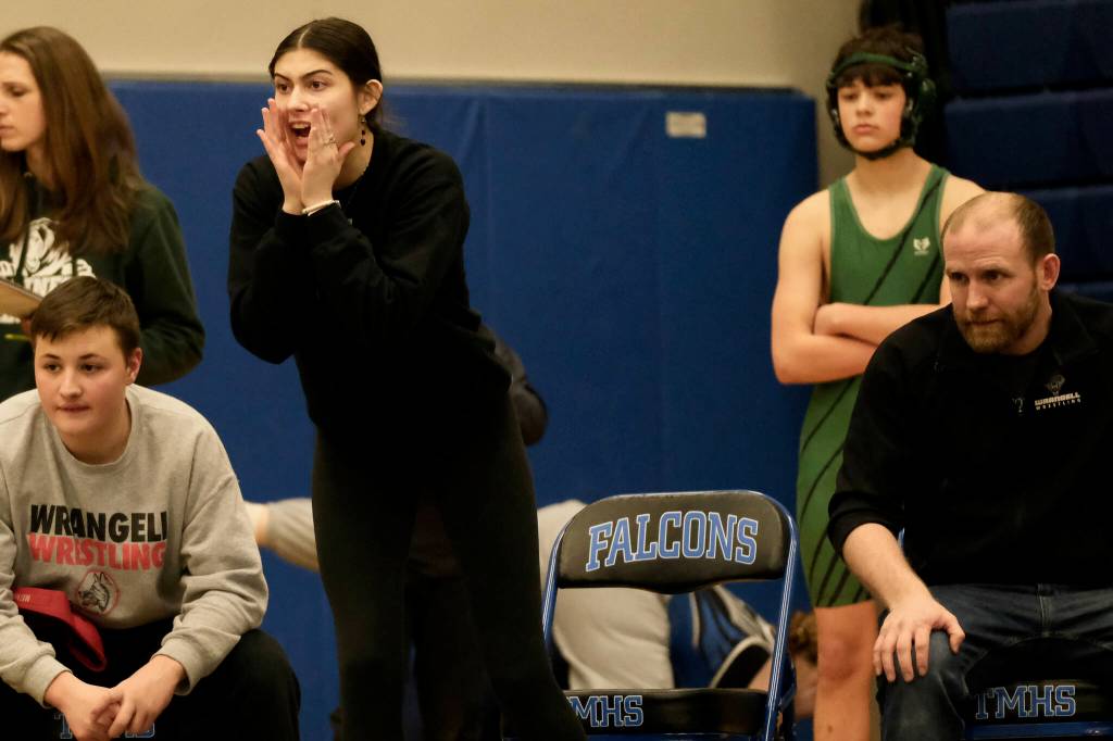 Wrangell senior Della Churchill shouts instructions to a Stikine Middle School wrestler as coach Jack Carney looks on during the Southeast Middle School Regional Wrestling Championships at Thunder Mountain Middle School last week. (Klas Stolpe / Juneau Empire)