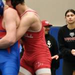 Wrangell senior Della Churchill mimics a wrestling grasp as she coaches a Stikine Wolves grappler during the Southeast Middle School Regional Wrestling Championships at Thunder Mountain Middle School last week. (Klas Stolpe / Juneau Empire)
