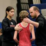 Wrangell senior Della Churchill and Stikine Middle School coach Jack Carney talk to Stikine Wolves grappler Radley Powers after his 85-pound match during the Southeast Middle School Regional Wrestling Tournament Saturday at Thunder Mountain Middle School in Juneau. (Klas Stolpe / Juneau Empire)