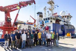 Researchers and crew members pose beside the University of Alaska Fairbanks research ship Sikuliaq in Dutch Harbor during a 2023 cruise to the Bering Sea to learn more about the Bering Land Bridge. (Photo by JR Ancheta)