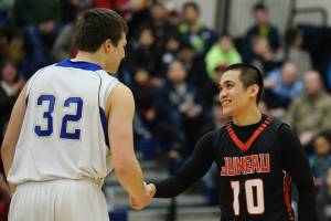 In this 2014 photo Thunder Mountain High School senior Ben Jahn (32) and Juneau-Douglas senior Kevin Guimmayen (10) shake hands before their game. Guimmayen passed from leukemia in 2017. Funds from Saturdays game will go to help Cancer Connection and childhood cancer awareness. Fridays game will support mental health through Take A Timeout To Talk supported by Find Your Fire and Juneau Suicide Prevention Coalition. (Klas Stolpe / Juneau Empire)