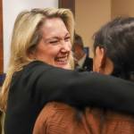 Tetyana Robbins, executive director of Project Alaska, embraces Deepika Ramesh Perumal, executive director of the Alaska Literacy Project, after a House Judiciary Committee meeting at the Alaska State Capitol Building on Feb. 19, 2025. The presentation to the Alaska Legislature was one of many in Juneau this week by immigration leaders in the state. (Jasz Garrett / Juneau Empire)
