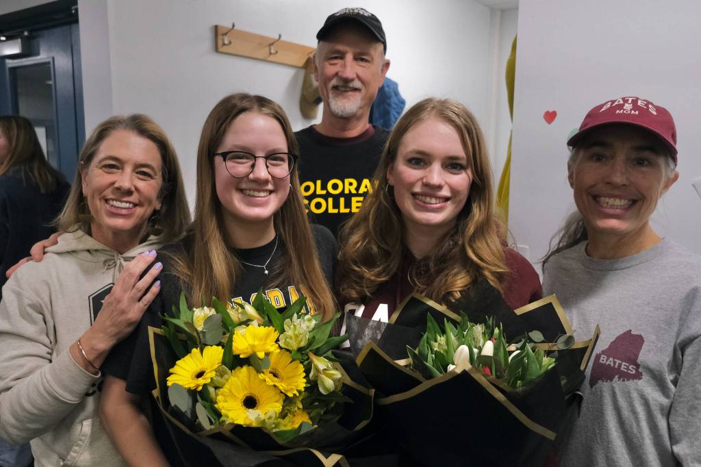 Mother Sara Chapell, Lucia Chapell, father Richard Chapell, Pacific Ricke and mother Kirsten Amann pose after Lucia and Pacific signed national letters of intent to become student-athletes at Colorado College and Bates College, respectively, Thursday at Augustus Brown Pool. (Klas Stolpe / Juneau Empire)