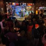 A singer performs at The Alaskan Hotel and Bar during a Fired Side Chats gathering Friday night to support fired federal government workers as well as those still employed. (Mark Sabbatini / Juneau Empire)