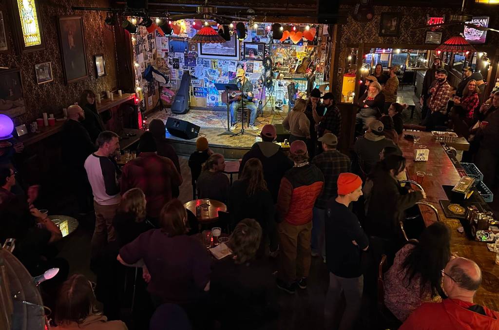 A singer performs at The Alaskan Hotel and Bar during a Fired Side Chats gathering Friday night to support fired federal government workers as well as those still employed. (Mark Sabbatini / Juneau Empire)