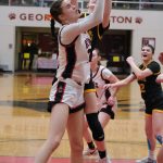 Juneau-Douglas High School: Yadaa.at Kalé senior Kerra Baxter rebounds with Monroe sophomore Leila Church during the Crimson Bears 40-33 loss to the Rams on Saturday in the George Houston Gymnasium. (Klas Stolpe / Juneau Empire)
