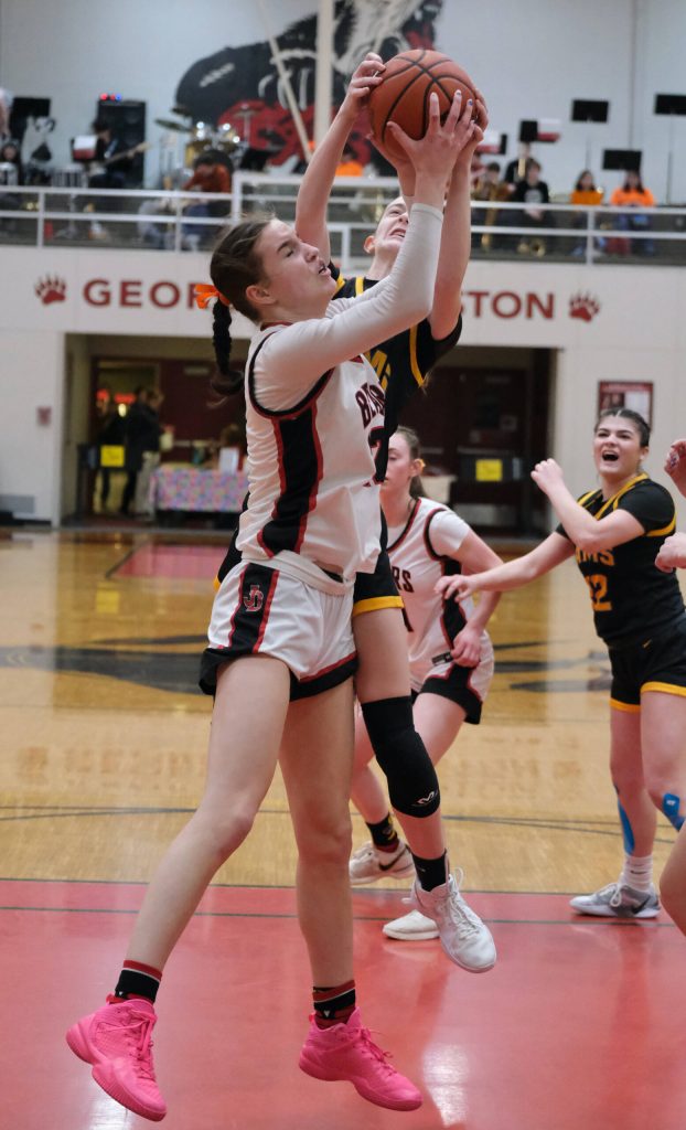 Juneau-Douglas High School: Yadaa.at Kalé senior Kerra Baxter rebounds with Monroe sophomore Leila Church during the Crimson Bears 40-33 loss to the Rams on Saturday in the George Houston Gymnasium. (Klas Stolpe / Juneau Empire)