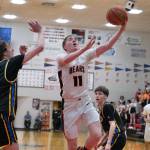 Juneau-Douglas High School: Yadaa.at Kalé senior Ben Sikes (11) shoots against the defense of Monroe senior Tucker Williams (0) during the Crimson Bears 71-55 loss to the Rams on Saturday in the George Houston Gymnasium. (Klas Stolpe / Juneau Empire)
