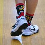 On Saturday all four varsity basketball teams from Juneau-Douglas High School: Yadaa.at Kalé and Monroe wore customized basketball socks with the special JDHS bear and childhood cancer logo as part of the Cancer Connection fundraiser. (Klas Stolpe / Juneau Empire)