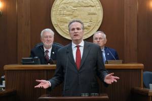 Gov. Mike Dunleavy delivers his State of the State speech at the Alaska State Capitol on Tuesday, Jan. 28, 2025, with Senate President Gary Stevens, at left, and House Speaker Bryce Edgmon, at right, in the background. (Klas Stolpe/Juneau Empire file photo)