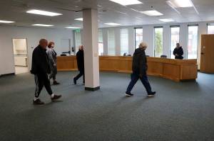 Juneau Assembly members and other visitors examine a meeting room in the Michael J. Burns Building formerly used by the Alaska State Board of Education and Early Development on Monday, April 8, 2024. (Mark Sabbatini / Juneau Empire file photo)