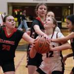 This file photo shows Klawock senior Lea Armour (23), eighth grader Jayla Edenshaw and senior Kaiya Marvin defending Juneau-Douglas High School: Yadaa.at Kalé sophomore Bergen Erickson (12) during this season's Capital City Classic in the George Houston Gymnasium. The Region V 1A basketball championships begin Wednesday at Thunder Mountain Middle School. (Klas Stolpe / Juneau Empire)