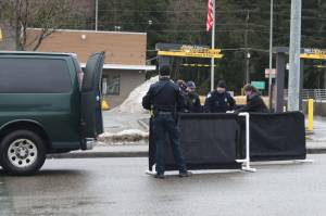Officials prepare to move Ashley Rae Johnston from the street where she was fatally shot by police on Wednesday, Dec. 25, 2025, near the Mendenhall Valley Breeze In. (Mark Sabbatini / Juneau Empire file photo)
