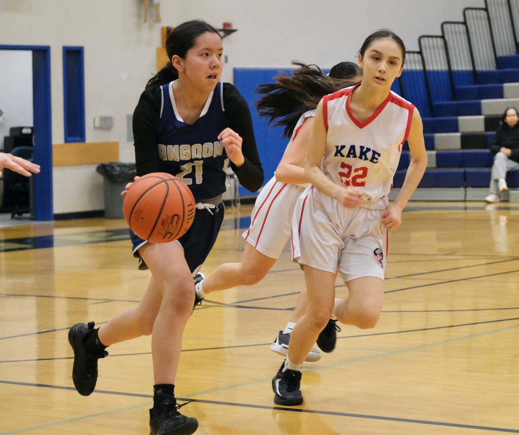 Angoon sophomore Ali Nelson (21) dribbles under pressure from Kake sophomore Madison Padgett (22) during the Eagles  54-12 loss to the Lady Thunderbirds on Wednesday during the 2025 Alaska Airlines Region V 1A Girls Basketball Tournament at Thunder Mountain Middle School. (Klas Stolpe / Juneau Empire)