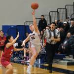 Klawock senior Lea Armour (23) throws a half court buzzer beater under pressure by Kake junior Lydia Chang on Thursday during the 2025 Alaska Airlines Region V 1A Girls Basketball Tournament at Thunder Mountain Middle School. (Klas Stolpe / Juneau Empire)