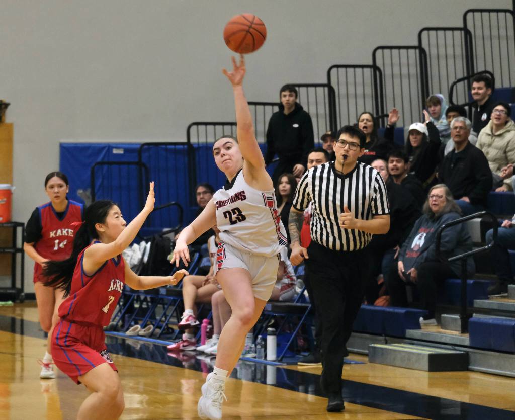 Klawock senior Lea Armour (23) throws a half court buzzer beater under pressure by Kake junior Lydia Chang on Thursday during the 2025 Alaska Airlines Region V 1A Girls Basketball Tournament at Thunder Mountain Middle School. (Klas Stolpe / Juneau Empire)