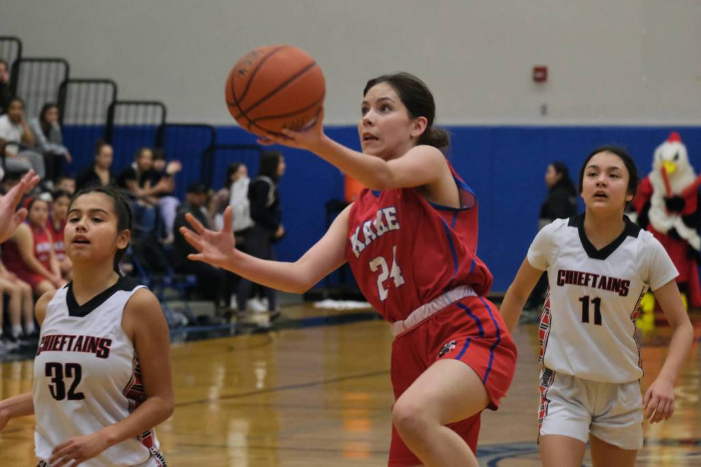 Kakes Brooklyn Hallingstad (24) lays up a shot past Klawocks Keira Sanderson (32) and Jayla Edenshaw (11) in the Thunderbirds loss to the Chieftains on Thursday during the 2025 Alaska Airlines Region V 1A Girls Basketball Tournament at Thunder Mountain Middle School. (Klas Stolpe / Juneau Empire)