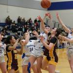 Hoonahs Chloe Lane (20) and Jora Savland go for a rebound with Skagways Lennon Jennings (21), Kelsey Cox (14), Amelia Myers (2) and Kenadie Cox (24) in the Braves overtime win over the Panthers Thursday during the 2025 Alaska Airlines Region V 1A Girls Basketball Tournament at Thunder Mountain Middle School. (Klas Stolpe / Juneau Empire)