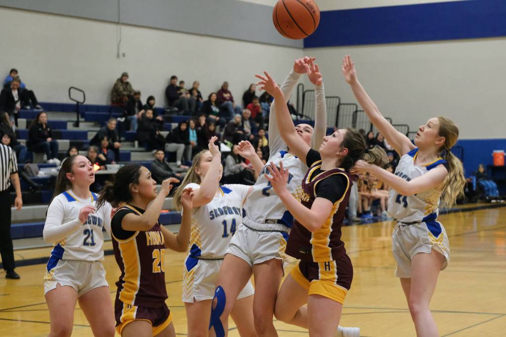 Hoonahs Chloe Lane (20) and Jora Savland go for a rebound with Skagways Lennon Jennings (21), Kelsey Cox (14), Amelia Myers (2) and Kenadie Cox (24) in the Braves overtime win over the Panthers Thursday during the 2025 Alaska Airlines Region V 1A Girls Basketball Tournament at Thunder Mountain Middle School. (Klas Stolpe / Juneau Empire)