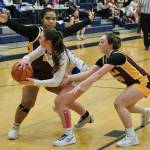 Skagways Lennon Jennings (21) passes around defensive pressure from Hoonahs Nevaeh Campbell (24) and Jora Savland (3) in the Panthers overtime loss to the Braves on Thursday during the 2025 Alaska Airlines Region V 1A Girls Basketball Tournament at Thunder Mountain Middle School. (Klas Stolpe / Juneau Empire)