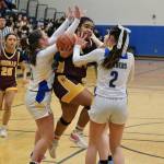 Hoonahs Nevaeh Campbell (24) shoots under pressure from Skagways Lennon Jennings (21), Kelsey Cox and Amelia Myers (2) in the Braves overtime win over the Panthers on Thursday during the 2025 Alaska Airlines Region V 1A Girls Basketball Tournament at Thunder Mountain Middle School. (Klas Stolpe / Juneau Empire)