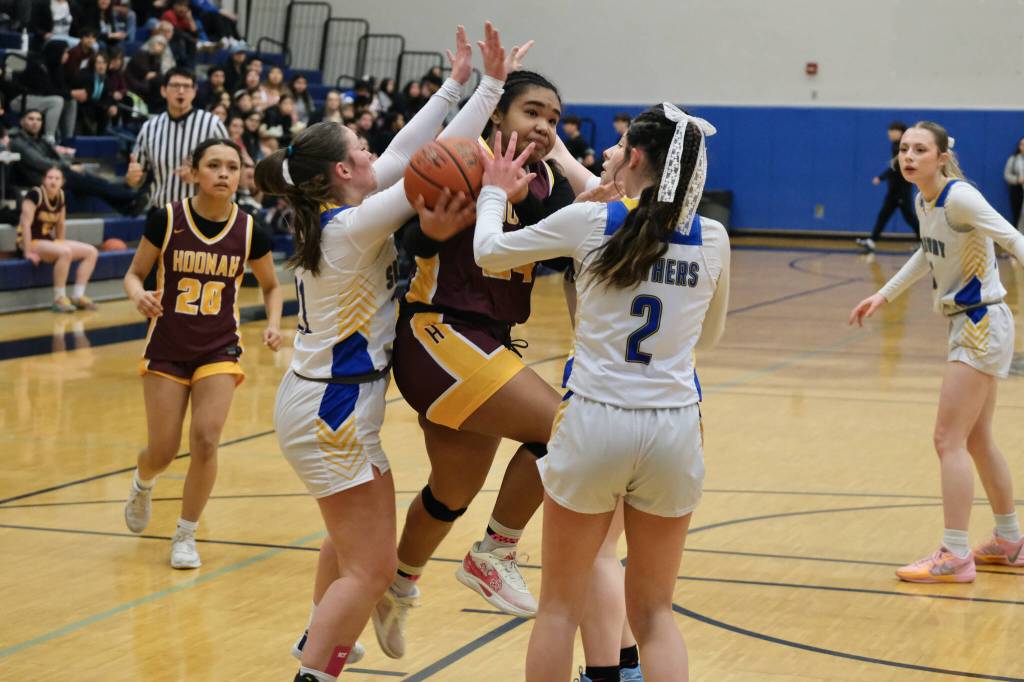 Hoonahs Nevaeh Campbell (24) shoots under pressure from Skagways Lennon Jennings (21), Kelsey Cox and Amelia Myers (2) in the Braves overtime win over the Panthers on Thursday during the 2025 Alaska Airlines Region V 1A Girls Basketball Tournament at Thunder Mountain Middle School. (Klas Stolpe / Juneau Empire)