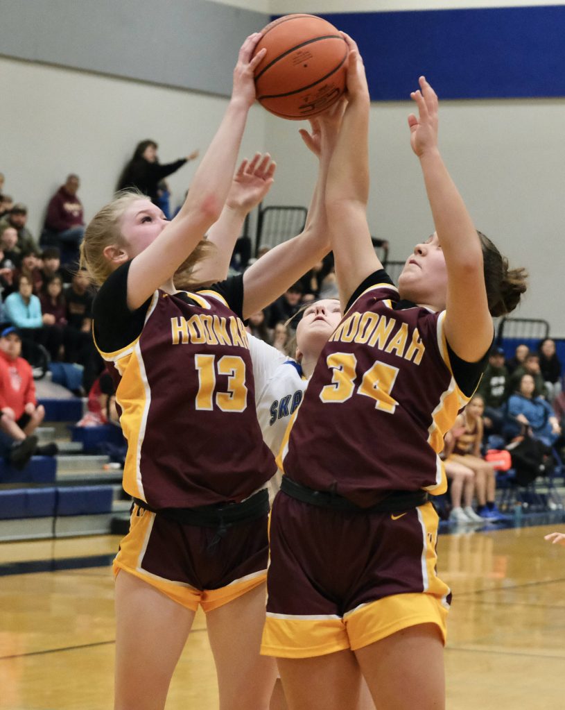 Hoonahs Paige Woitte (13) and Charlie Jack (34) rebound over Skagways Kelsey Cox in the Braves overtime win over the Panthers on Thursday during the 2025 Alaska Airlines Region V 1A Girls Basketball Tournament at Thunder Mountain Middle School. (Klas Stolpe / Juneau Empire)