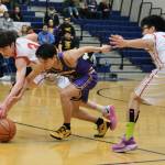 Kakes Talen Davis (3) and Josiah Jackson (21) force a ball loose from Hydaburgs Ricky Alander in the Thunderbirds win over the Warriors on Thursday during the 2025 Alaska Airlines Region V 1A Boys Basketball Tournament at Thunder Mountain Middle School. (Klas Stolpe / Juneau Empire)