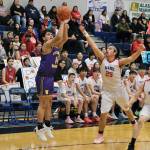 Hydaburgs Lorin Sanderson (14) shoots under pressure from Kakes Aiden Clark (25) in the Warriors loss to the Thunderbirds on Thursday during the 2025 Alaska Airlines Region V 1A Boys Basketball Tournament at Thunder Mountain Middle School. (Klas Stolpe / Juneau Empire)